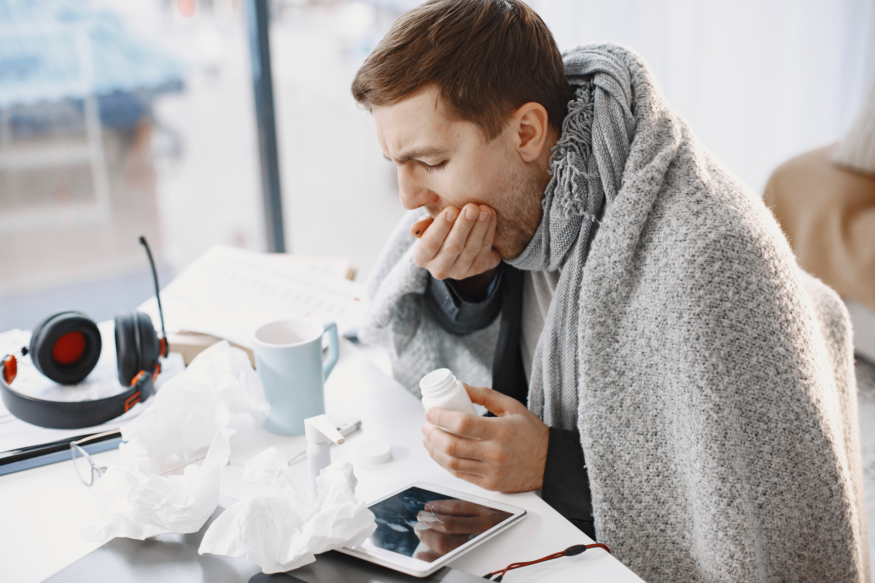 A Sick Man Covering His Mouth